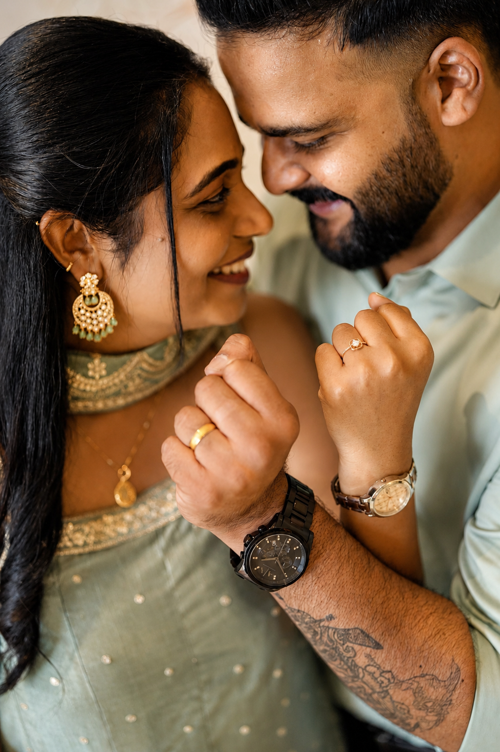 Close-up of their engagement rings with joyful smiles